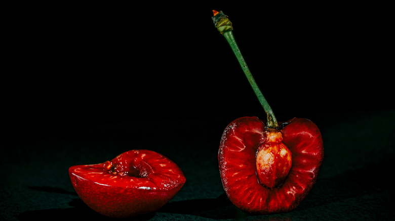 A vibrant red cherry split in half
