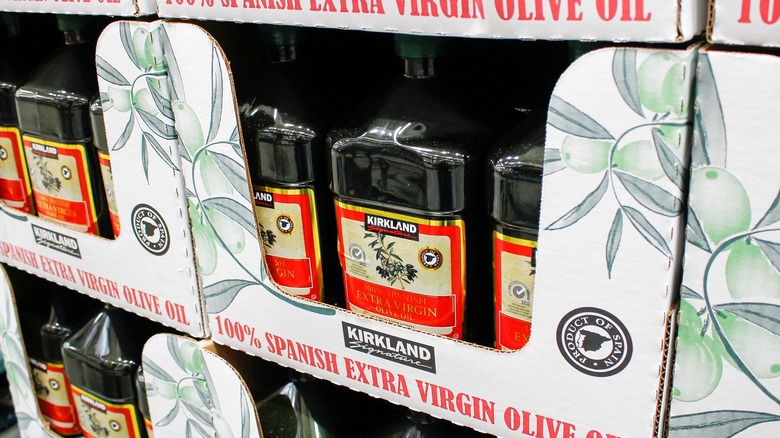 bottles of kirkland signature 100% spanish extra virgin olive oil on display at costco