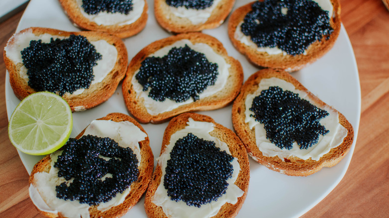 Caviar and butter on toast with lemon half