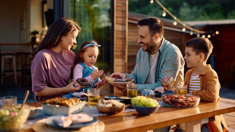 Happy family eating around a table