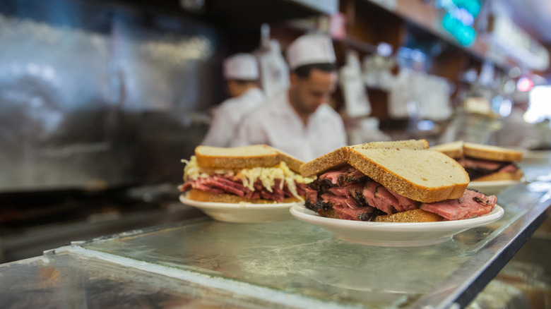 Rye and pastrami sandwiches on a deli counter