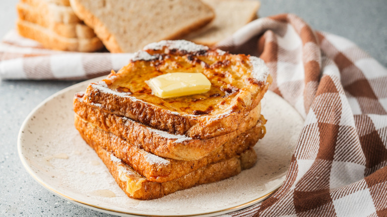 a plate of French toast topped with butter