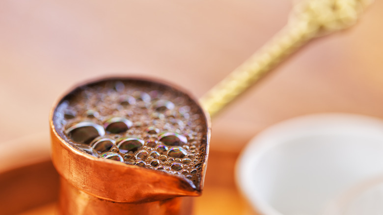 Closeup of Greek coffee bubbling in briki pot
