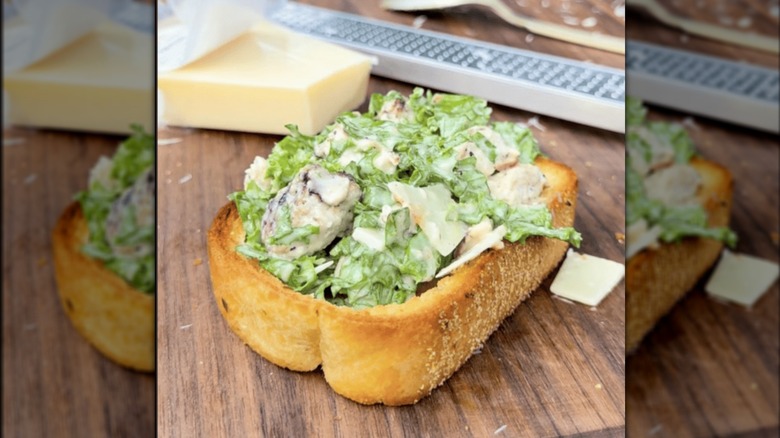 Salad served inside a piece of garlic bread