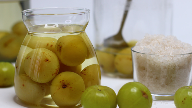 Pickled gooseberries in jars with brine