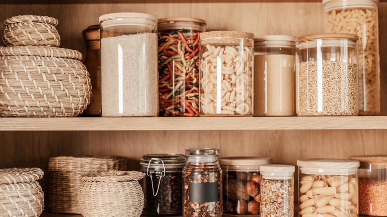 Pantry cabinet shelves with canisters and baskets.