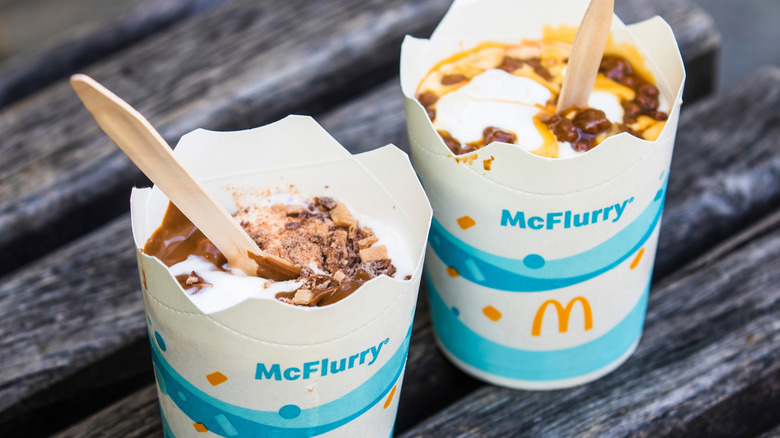 Two McFlurry ice cream desserts with open lids.