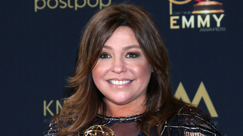 Rachael Ray smiling at a red carpet event.