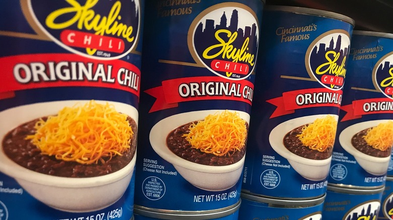 Cans of Skyline Chili on the grocery store shelf.