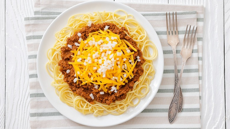 Bowl of Cincinnati-style chili and cheese over spaghetti.