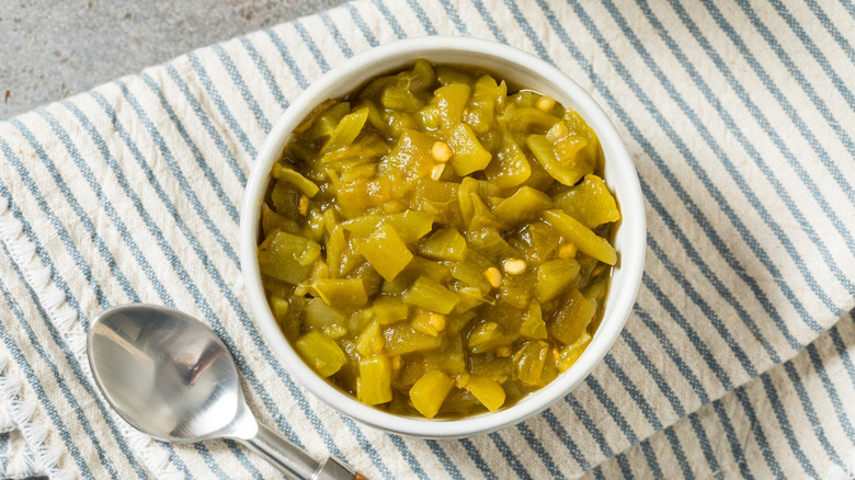 A bowl of diced green chiles site on a napkin