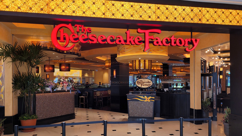 An exterior shot of The Cheesecake Factory, empty of people yet still looking warm and welcoming
