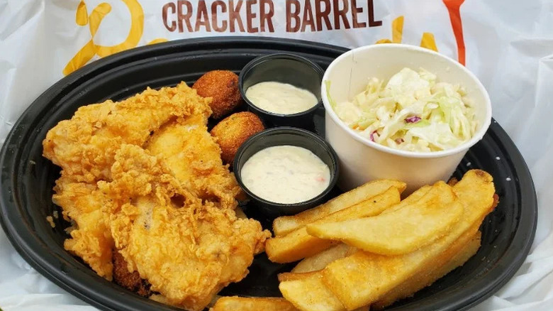Cracker Barrel's fish fry dish with fries, hush puppies, and coleslaw