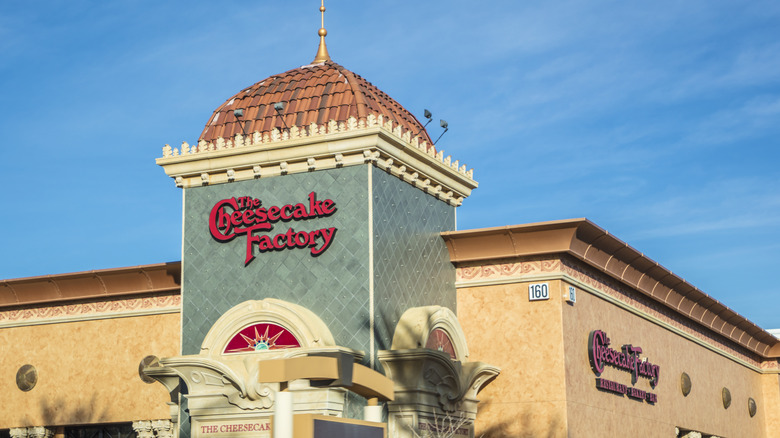 The exterior of a cheesecake factory restaurant.