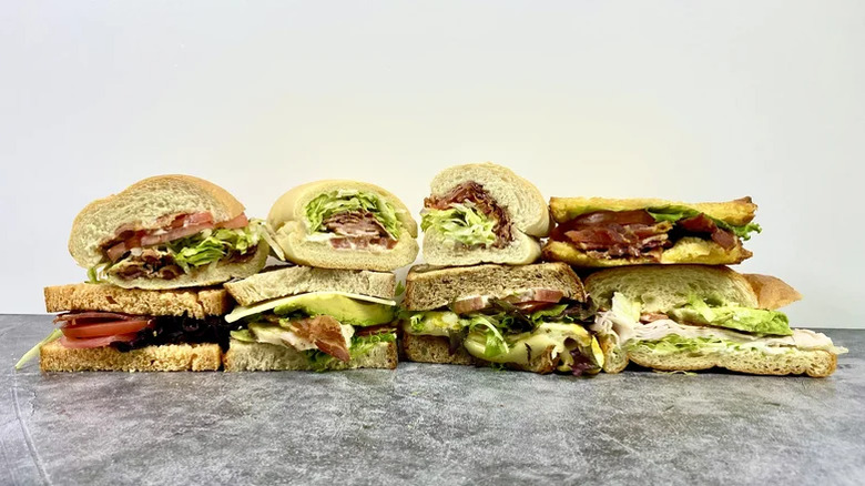 A selection of chain restaurant BLTs stacked on top of each other.