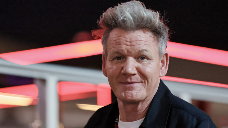 Portrait photo of Gordon Ramsay outside at night.
