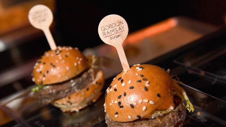 A pair of burgers from a Gordon Ramsay restaurant in close-up.