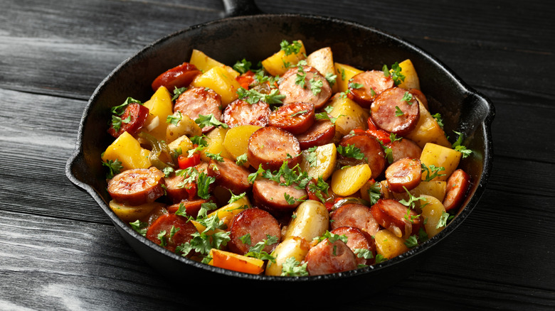 roasted sausage and potatoes in a cast iron pan