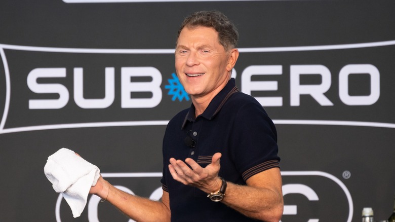 The celebrity chef Bobby Flay on stage at an event.