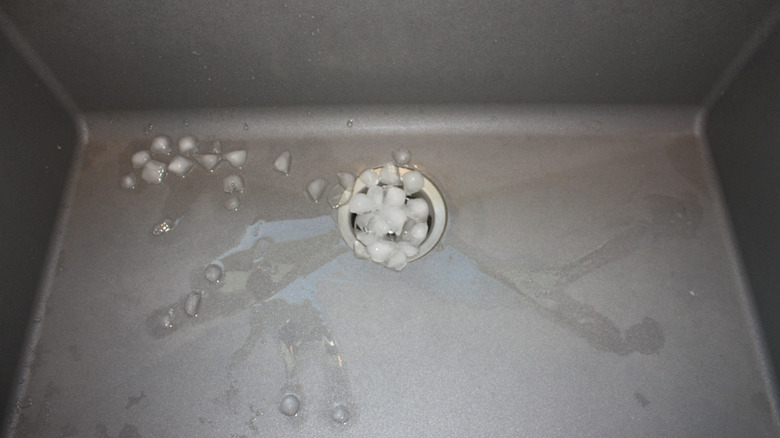 Ice in garbage disposal of steel sink