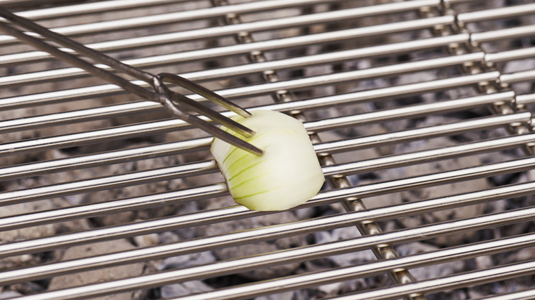 clean grill with half white onion
