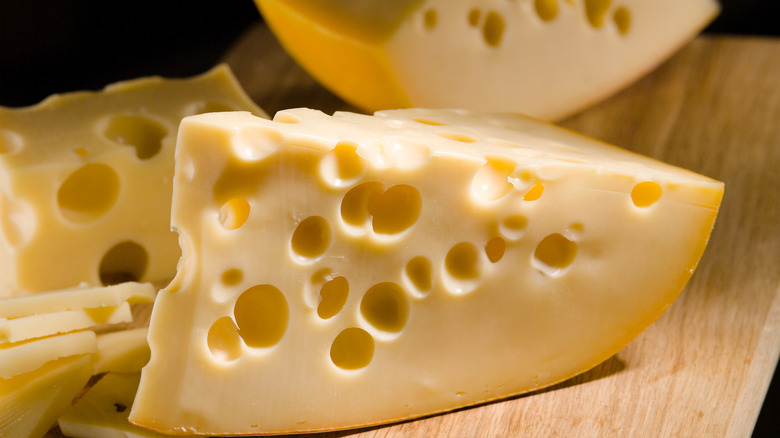 Chunks of Swiss cheese on a cutting board