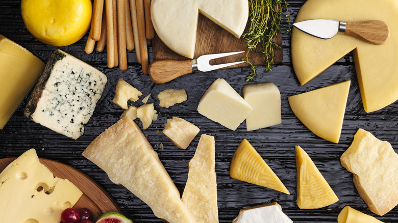 An assortment of cheese on a black table