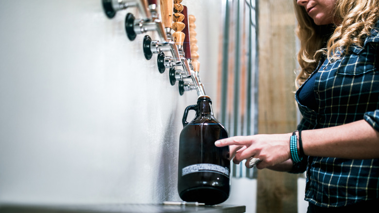 Person filling a growler from tap