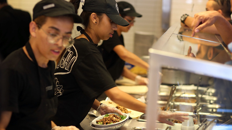 Chipotle employees assembling bowls at Chipotle