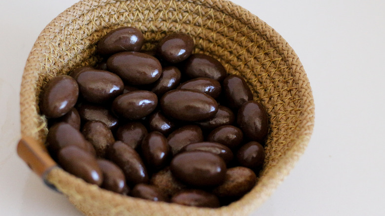 Basket of dark chocolate almonds