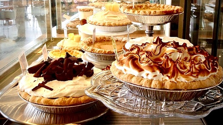 A display of fancy pies in a shop window.