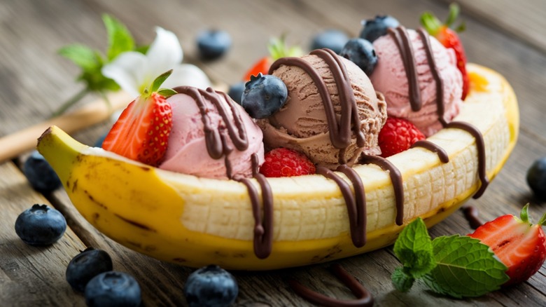 A banana split with chocolate and strawberry ice cream