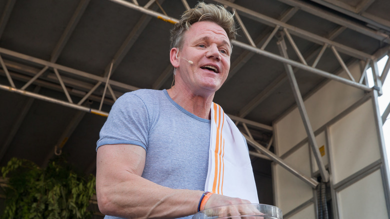 Gordon Ramsay with a kitchen towel over his shoulder