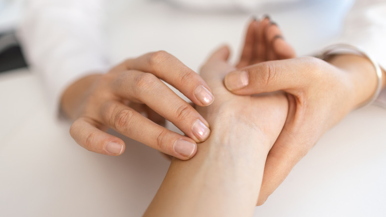 person holding someone's inside wrist