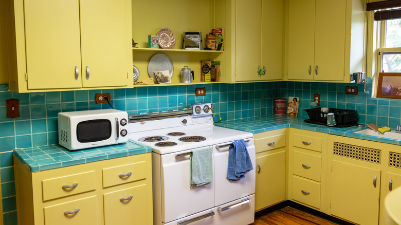A yellow and blue 1940s kitchen.