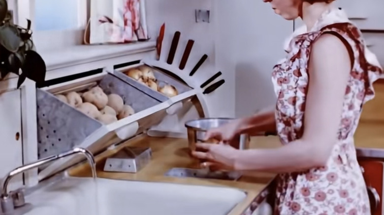 Storage bins built into a vintage kitchen.