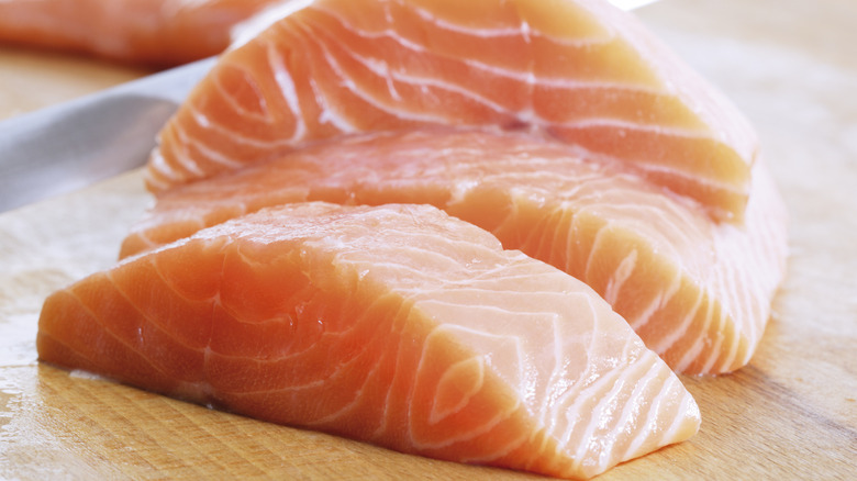 Slices of salmon fillet on a cutting board
