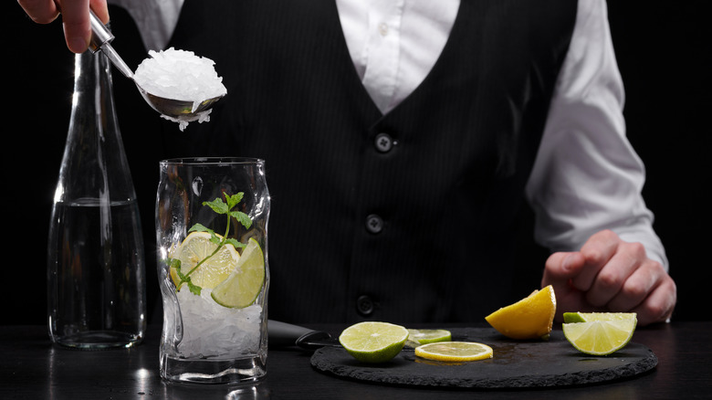bartender adding crushed ice to glass