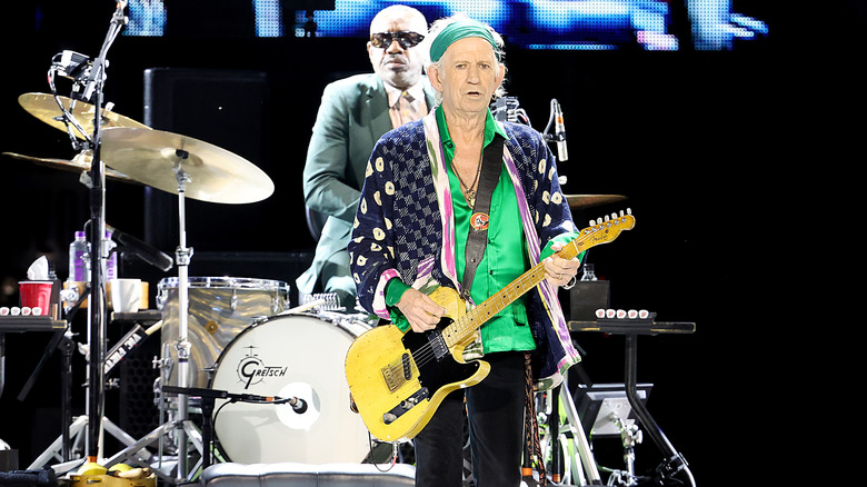 Keith Richards on stage holding a guitar