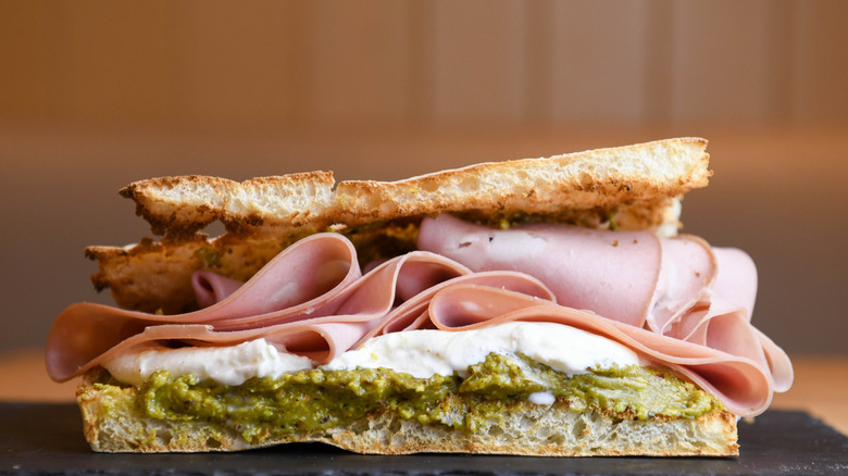 A sandwich with mortadella in it.
