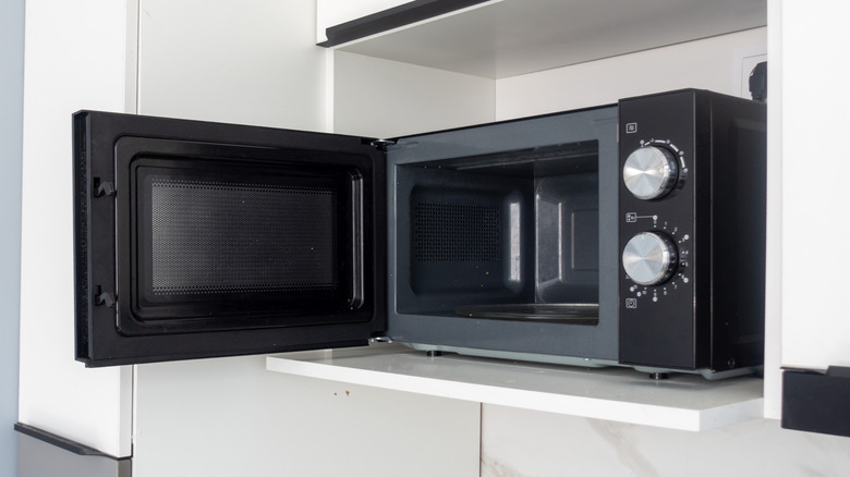 Open microwave in cabinet