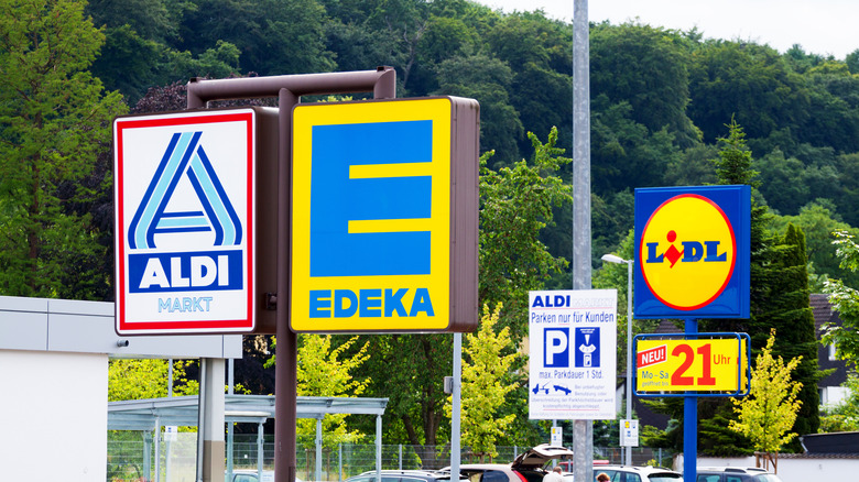 Lidl and Aldi supermarket signs displayed next to each other.