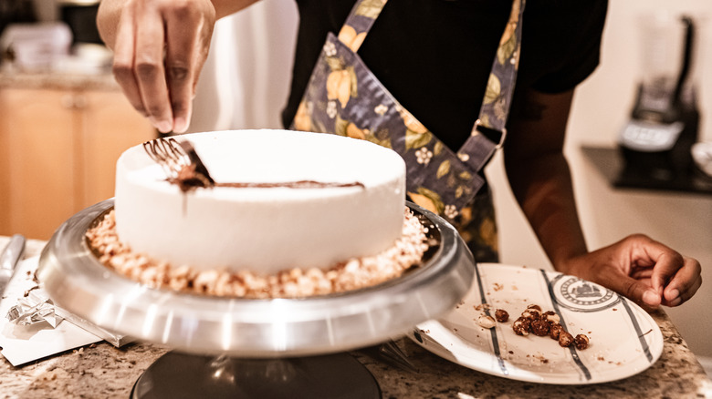 Woman frosting a cake