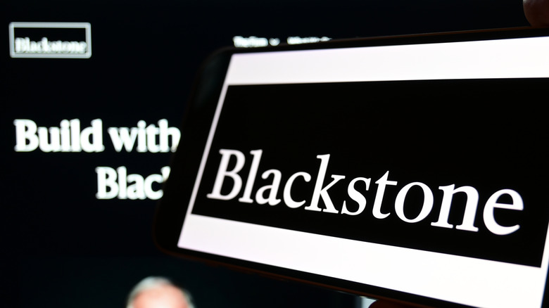 Blackstone logo on a laptop screen and computer screen behind it