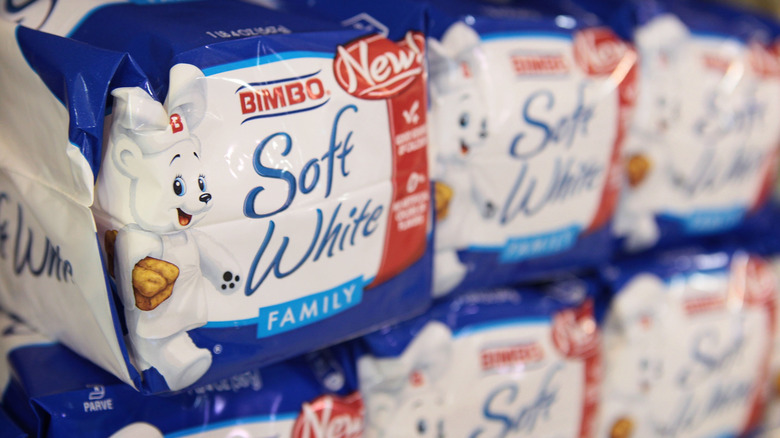 A close up of Bimbo Soft White bread on grocery shelves