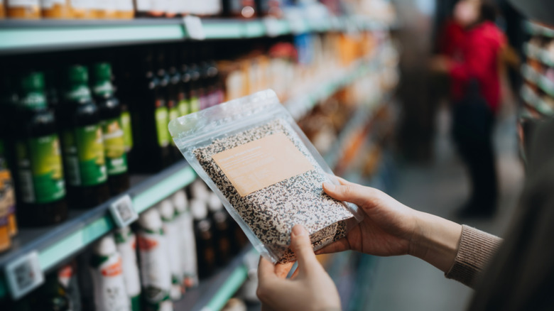 couple looking for food in grocery store