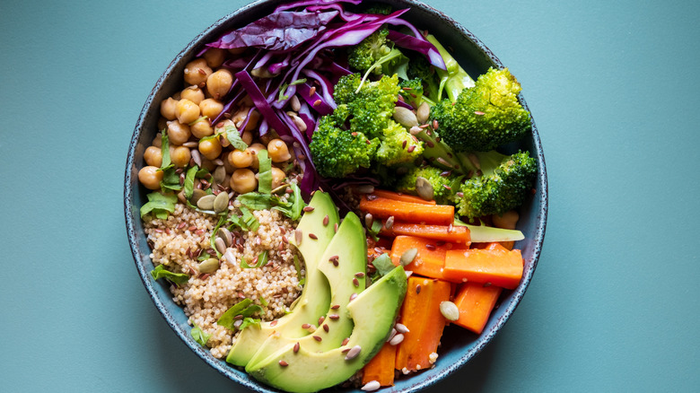 colorful quinoa bowl on blue background