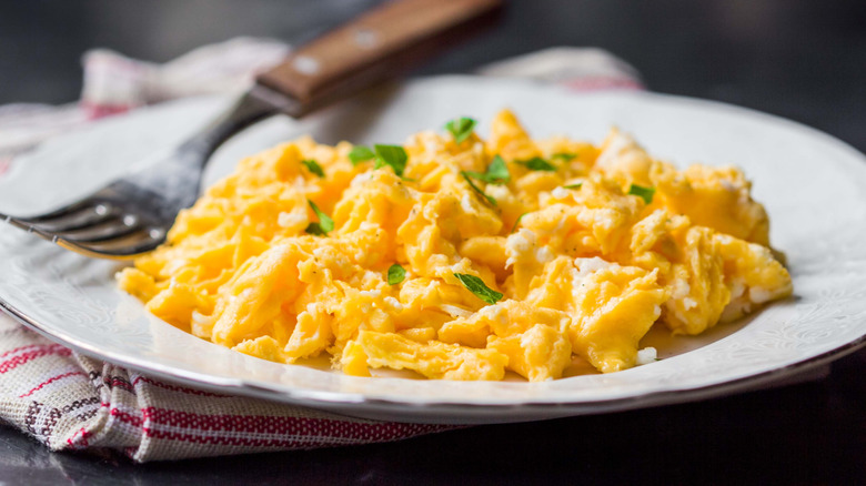 Scrambled eggs with fresh herbs on a plate