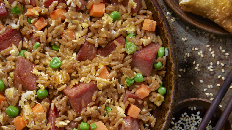 Closeup of Spam fried rice in a bowl with sesame seeds on the side