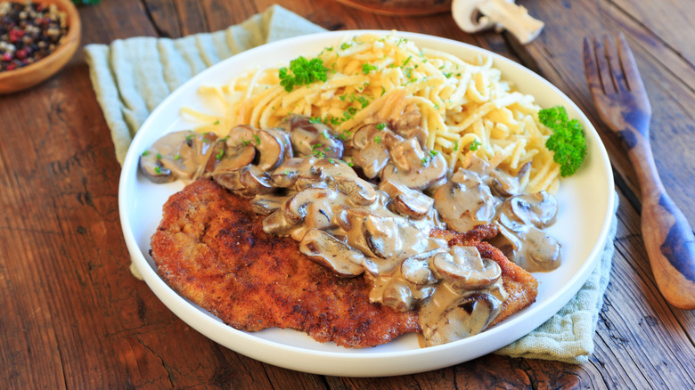 Hunter-style schnitzel on a rustic table.